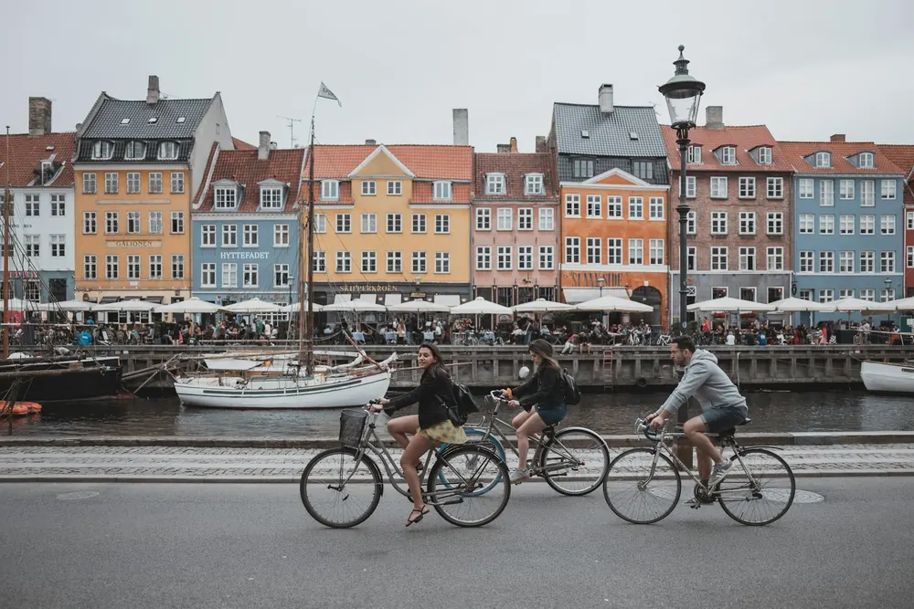 Cyclists passing the colorful waterfront in Copenhagen
